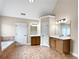 A spacious bathroom has double vanities, a jacuzzi tub, and private toilet rooms at 400 Icicle Ct, Hampton, GA 30228
