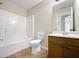 Bathroom featuring a combination shower and tub, toilet, and vanity with ample cabinet space at 400 Icicle Ct, Hampton, GA 30228