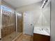 Modern bathroom featuring a glass-enclosed shower and a sleek vanity with a white marble countertop at 400 Icicle Ct, Hampton, GA 30228