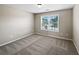 Cozy bedroom with neutral carpet, a bright window, and ample space for furnishings at 400 Icicle Ct, Hampton, GA 30228