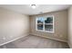 This bedroom features a large window with natural light and a neutral color scheme at 400 Icicle Ct, Hampton, GA 30228