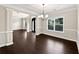 Dining room featuring dark hardwood floors, decorative pillars, and neutral walls at 400 Icicle Ct, Hampton, GA 30228