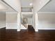 A two-story foyer boasts hardwood floors, a stairway with wood trim, and decorative pillars at 400 Icicle Ct, Hampton, GA 30228