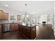 Modern kitchen with an island cooktop, stainless steel appliances, and an open layout to the living space at 400 Icicle Ct, Hampton, GA 30228