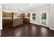 Open kitchen features dark wood cabinets, an island, stainless appliances, and dark hardwood flooring at 400 Icicle Ct, Hampton, GA 30228