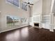 Sun-filled living room with a cozy fireplace, built-in shelving, and gleaming hardwood floors at 400 Icicle Ct, Hampton, GA 30228