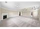 A spacious living room features neutral walls, a fireplace, recessed lighting, and plush carpeting at 400 Icicle Ct, Hampton, GA 30228