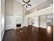 A two-story living room features hardwood floors, built in shelves, and a fireplace at 400 Icicle Ct, Hampton, GA 30228
