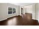 Living room with dark hardwood floors, pillars, and neutral walls at 400 Icicle Ct, Hampton, GA 30228