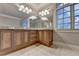 Bathroom vanity featuring double mirrors, granite countertop, and wooden cabinets at 6273 Clapham Ln, Johns Creek, GA 30097