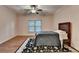 Cozy bedroom featuring wood floors and a decorative ceiling fan at 6273 Clapham Ln, Johns Creek, GA 30097