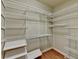 Spacious walk-in closet offers adjustable shelving for optimal storage at 6273 Clapham Ln, Johns Creek, GA 30097
