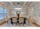 Elegant dining room with coffered ceilings, hardwood floors, and a modern chandelier at 6273 Clapham Ln, Johns Creek, GA 30097