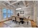 Elegant dining room with coffered ceilings, hardwood floors, and a modern chandelier at 6273 Clapham Ln, Johns Creek, GA 30097