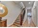 Open hallway with hardwood floors, a staircase, and view of living room at 6273 Clapham Ln, Johns Creek, GA 30097