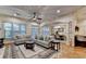 Cozy living room area featuring hardwood floors, neutral walls, with adjacent dining area at 6273 Clapham Ln, Johns Creek, GA 30097