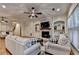 Comfortable living room with hardwood floors, a fireplace with a tv, and lots of natural light at 6273 Clapham Ln, Johns Creek, GA 30097