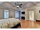Spacious main bedroom with hardwood floors, fireplace, and lots of light at 6273 Clapham Ln, Johns Creek, GA 30097