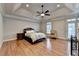 Main bedroom with tray ceiling, fireplace, and hardwood floors at 6273 Clapham Ln, Johns Creek, GA 30097