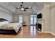 Spacious main bedroom with fireplace, tray ceilings, and hardwood flooring at 6273 Clapham Ln, Johns Creek, GA 30097