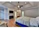 Spacious main bedroom featuring hardwood floors, trey ceiling, and fireplace at 6273 Clapham Ln, Johns Creek, GA 30097