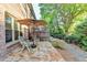 Charming patio with stone flooring, umbrella, and seating area at 6273 Clapham Ln, Johns Creek, GA 30097
