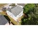Aerial shot of the home and backyard featuring a wooden deck, mature trees, and a lush lawn at 985 Forest Knoll Court Ct, Lithia Springs, GA 30122