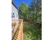 Lovely, green backyard featuring a wooden fence and deck at 985 Forest Knoll Court, Lithia Springs, GA 30122