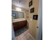 Neutral-toned bathroom featuring dual sinks, a large mirror, and serene decorations at 985 Forest Knoll Court, Lithia Springs, GA 30122