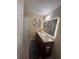 Bright bathroom with double sinks, illuminated mirror, and dark wood cabinetry at 985 Forest Knoll Court, Lithia Springs, GA 30122