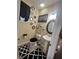 Elegant bathroom with pedestal sink, decorative mirrors, patterned rugs, and black accents at 985 Forest Knoll Court, Lithia Springs, GA 30122