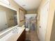 Well-lit bathroom featuring large mirror, updated vanity, and neutral tiling at 985 Forest Knoll Court Ct, Lithia Springs, GA 30122