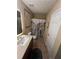 Bathroom with a modern vanity, floral shower curtain, and coordinated décor at 985 Forest Knoll Court, Lithia Springs, GA 30122