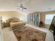Spacious bedroom with ceiling fan, carpet, large rug, and sitting area at 985 Forest Knoll Court Ct, Lithia Springs, GA 30122