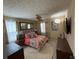 Well-lit bedroom with comfortable bedding, ceiling fan, and dark wood furnishings at 985 Forest Knoll Court, Lithia Springs, GA 30122