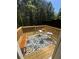 Inviting wooden deck featuring an outdoor rug, patio furniture, and beautiful trees surrounding it at 985 Forest Knoll Court, Lithia Springs, GA 30122