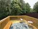 Newly constructed wooden deck with outdoor seating, and wooded view at 985 Forest Knoll Court Ct, Lithia Springs, GA 30122