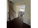 View of entry hall with hardwood floors, staircase, and an open living space with lots of natural light at 985 Forest Knoll Court, Lithia Springs, GA 30122