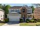 Charming two-story home boasts a well-manicured lawn and a two-car garage at 985 Forest Knoll Court Ct, Lithia Springs, GA 30122