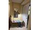 Hallway nook featuring a sitting bench, mirror, and a view into an adjacent living space at 985 Forest Knoll Court, Lithia Springs, GA 30122