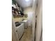 Functional laundry room with washer and dryer, plus storage shelves at 985 Forest Knoll Court, Lithia Springs, GA 30122