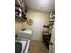 Functional laundry room with storage shelves, appliances, tiled floor, and easy access at 985 Forest Knoll Court, Lithia Springs, GA 30122