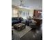 Open-concept kitchen and living room, featuring a large sectional, chairs, and an island with seating at 985 Forest Knoll Court, Lithia Springs, GA 30122