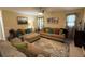 Comfortable living room with neutral tones, a ceiling fan, natural light, and plenty of seating at 985 Forest Knoll Court, Lithia Springs, GA 30122