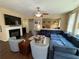 Cozy living room with a fireplace, a large sectional sofa, and stylish armchairs at 985 Forest Knoll Court Ct, Lithia Springs, GA 30122