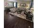 The living room features a dining area with hardwood floors, patterned rugs, and natural lighting at 985 Forest Knoll Court, Lithia Springs, GA 30122