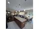 View of the kitchen and living room featuring an island with seating, a large sectional sofa, and modern decor at 985 Forest Knoll Court, Lithia Springs, GA 30122