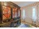 Elegant entryway with a decorative display cabinet and classic decor at 2985 Duke Of Gloucester, Atlanta, GA 30344