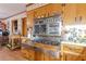 View of a kitchen with a vintage range, wooden cabinets, and white countertops at 2985 Duke Of Gloucester, Atlanta, GA 30344