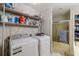 Functional laundry area with washer, dryer, and storage shelves at 2985 Duke Of Gloucester, Atlanta, GA 30344